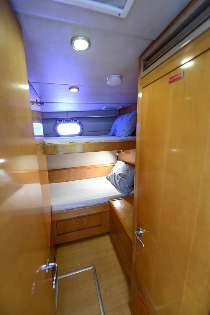 a person sitting in a chair in a kitchen aboard MAHA Yacht for Sale