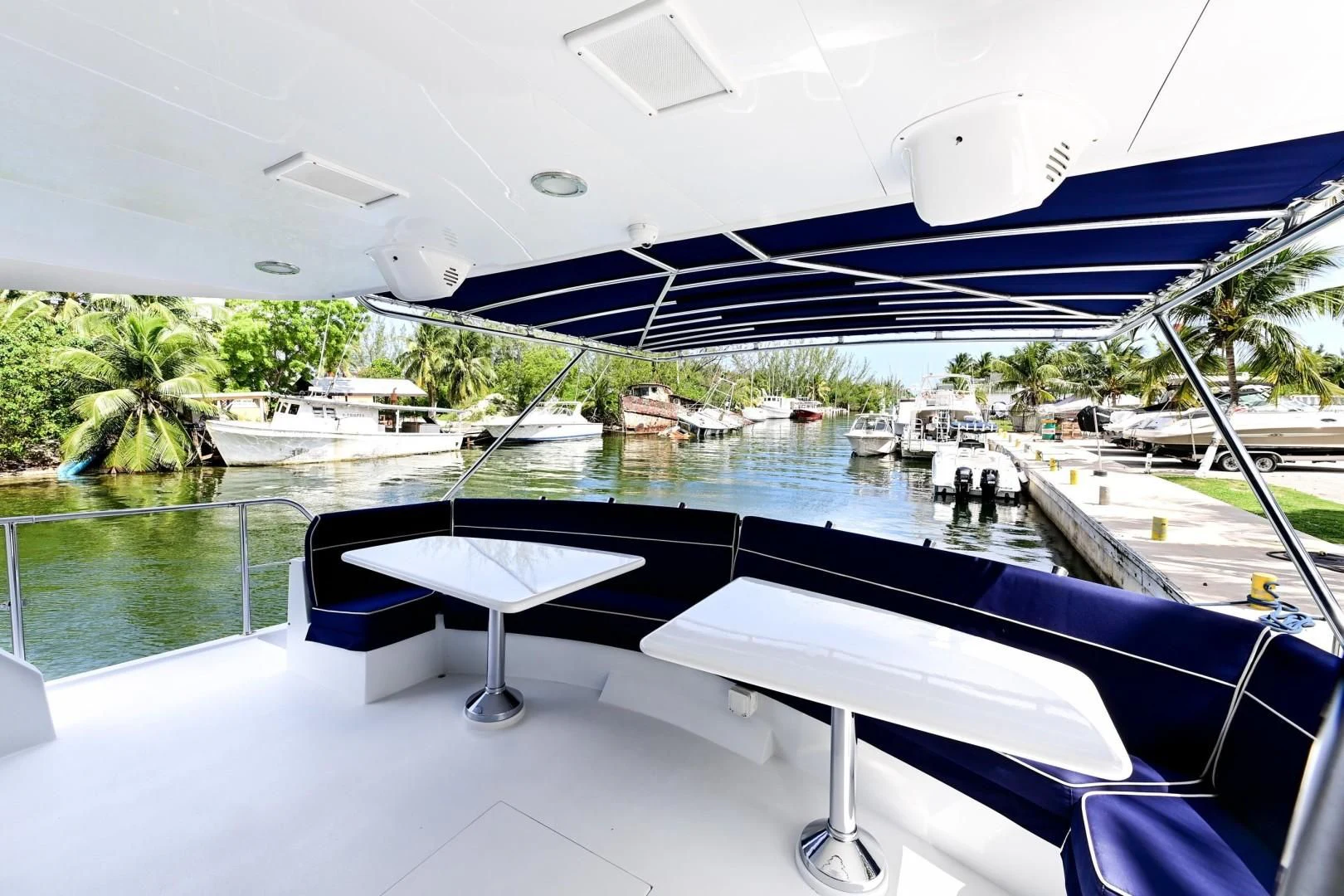 a pool with a table and chairs aboard MAHA Yacht for Sale