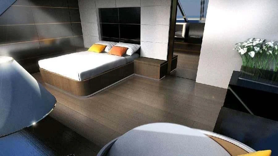 a room with a bed and a chair aboard ESPIRITU DEL XAREY Yacht for Sale