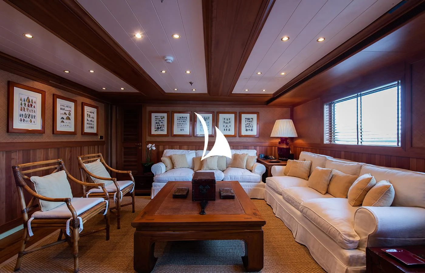 a living room with a couch and a table aboard BLEU DE NIMES Yacht for Charter