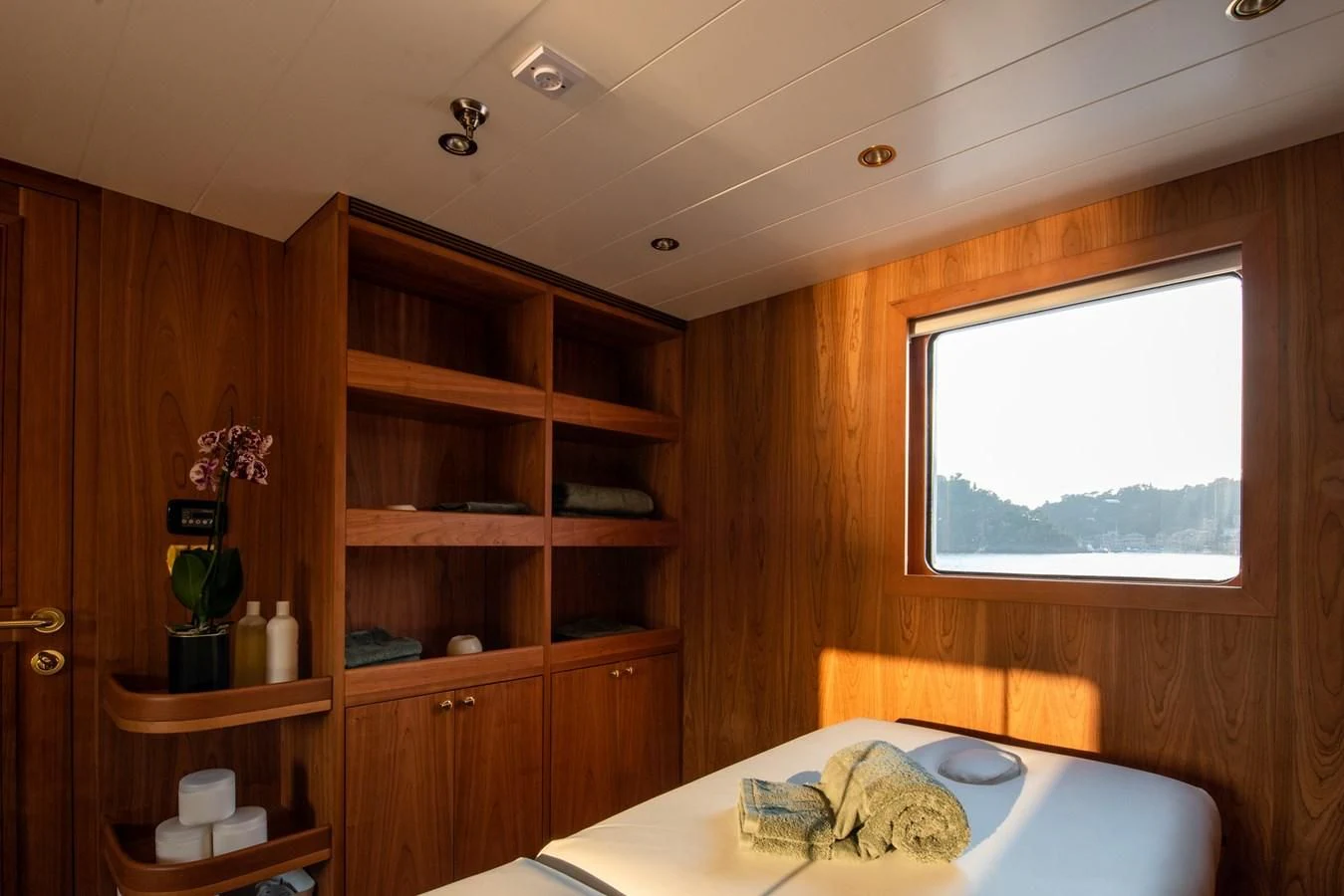 a room with a bed and a window aboard BLEU DE NIMES Yacht for Charter
