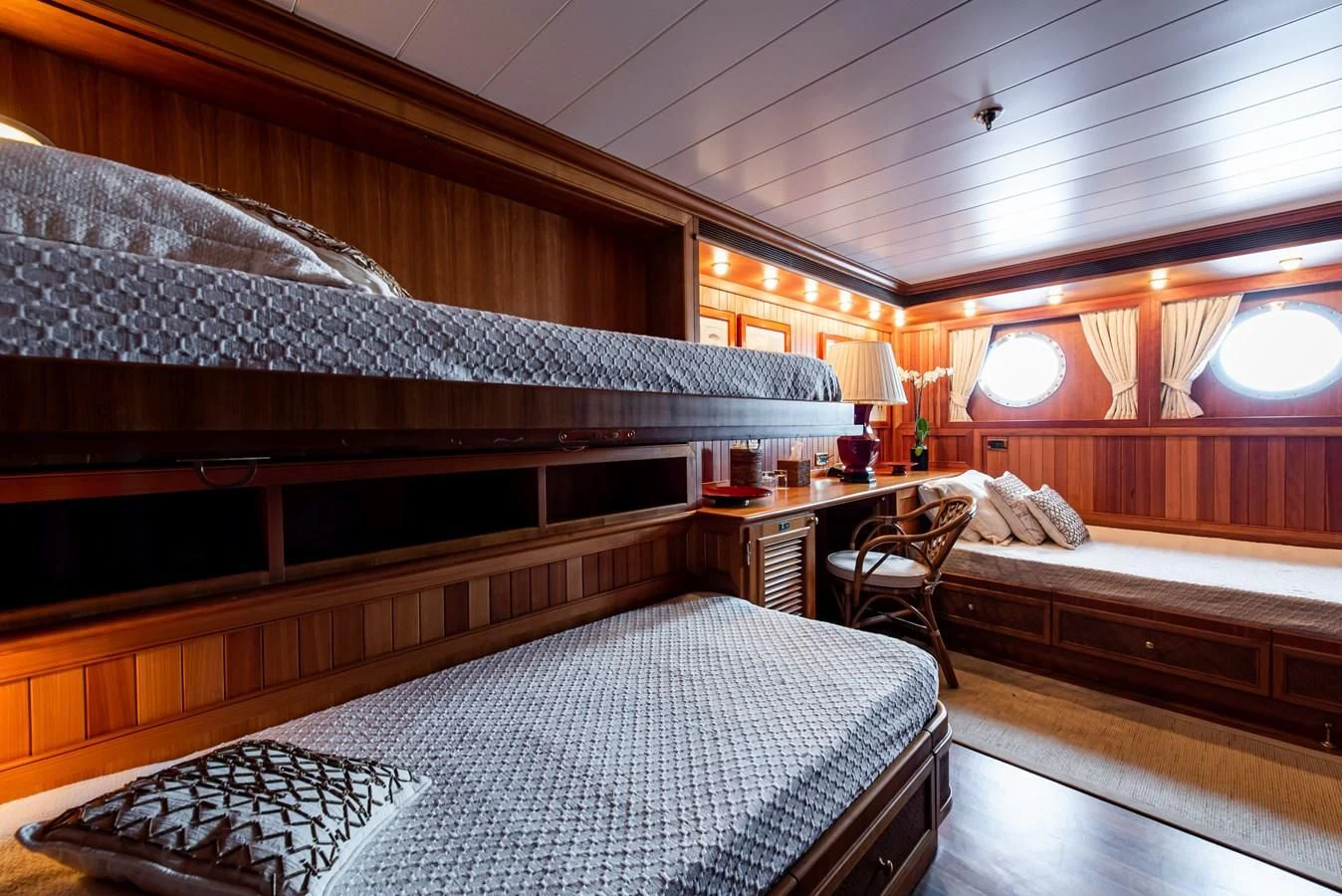 a room with a bed and a desk aboard BLEU DE NIMES Yacht for Charter