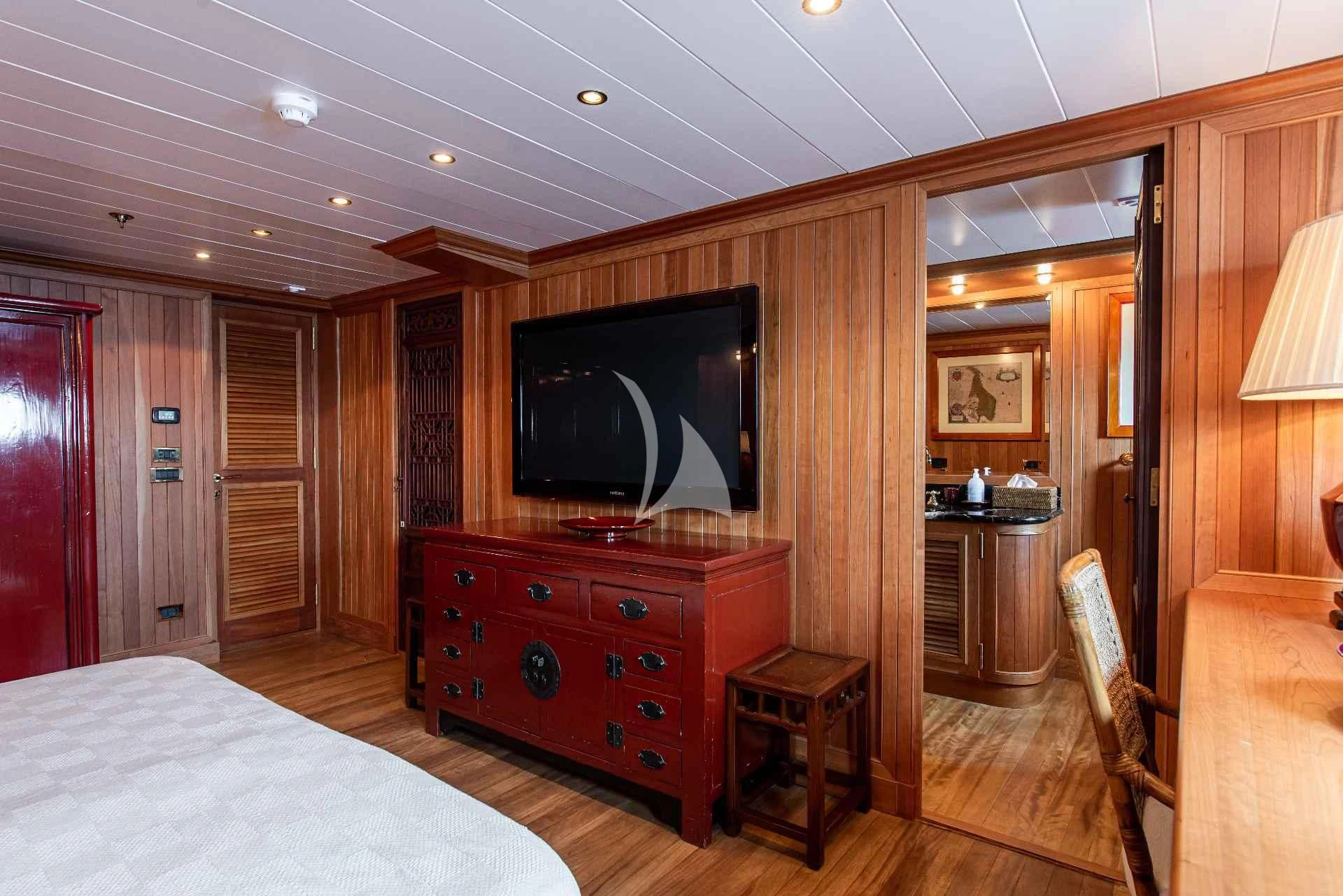 a bedroom with a tv and a bed aboard BLEU DE NIMES Yacht for Charter