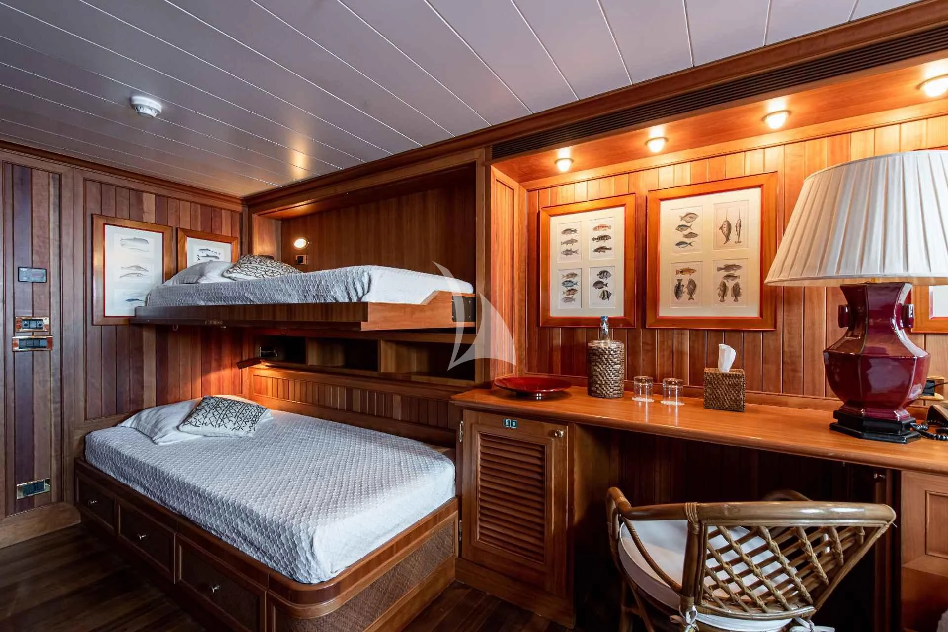a bedroom with a bed and a desk aboard BLEU DE NIMES Yacht for Charter
