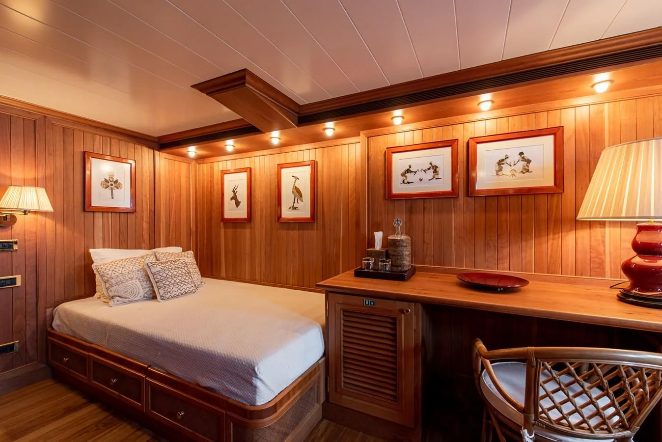 a room with a bed and a desk aboard BLEU DE NIMES Yacht for Charter