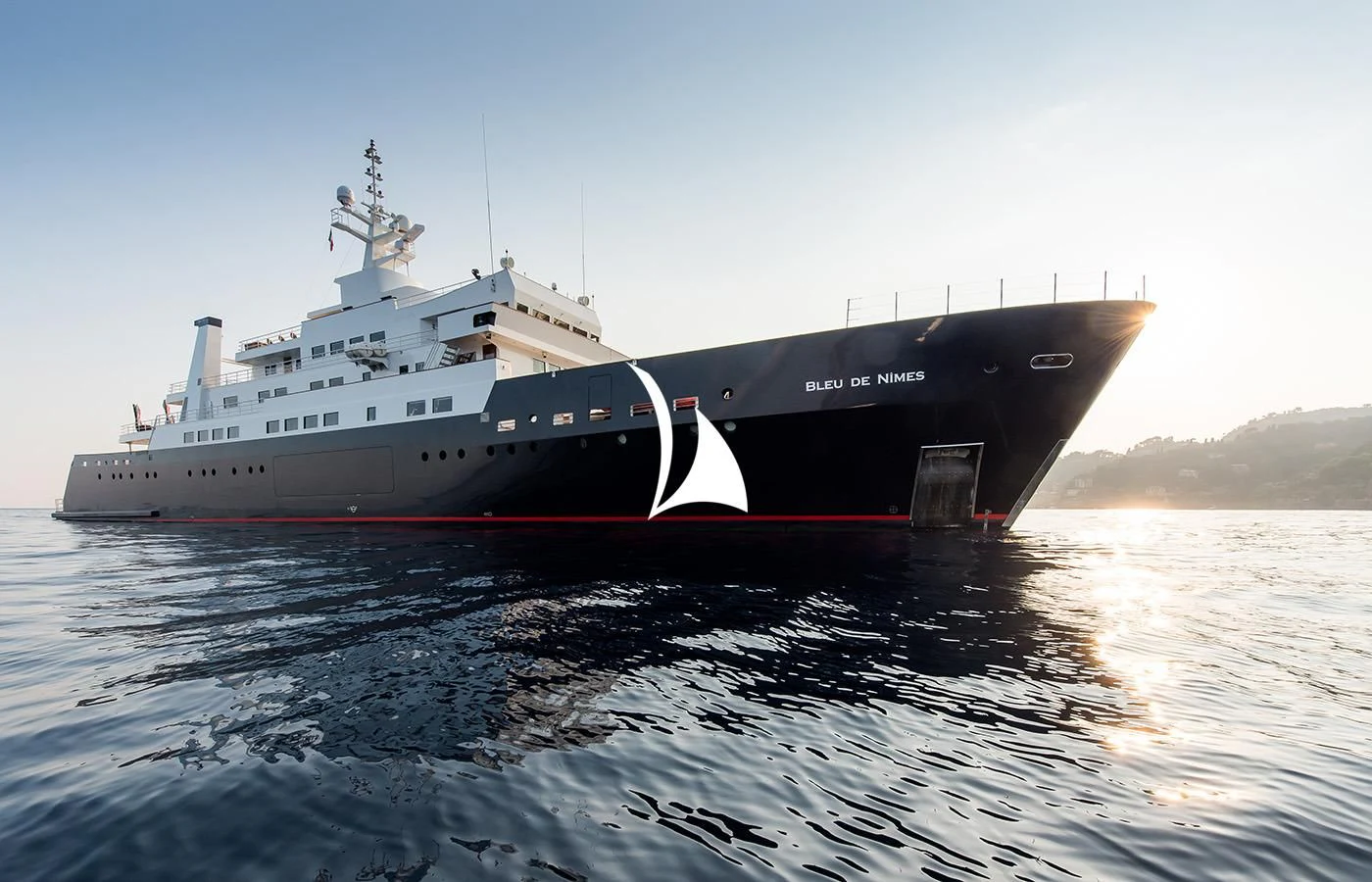 a large ship on the water aboard BLEU DE NIMES Yacht for Charter