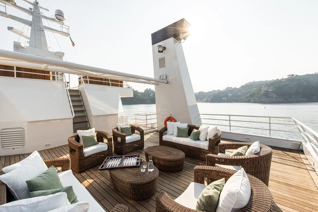 a deck with a large white statue and chairs on it aboard BLEU DE NIMES Yacht for Charter