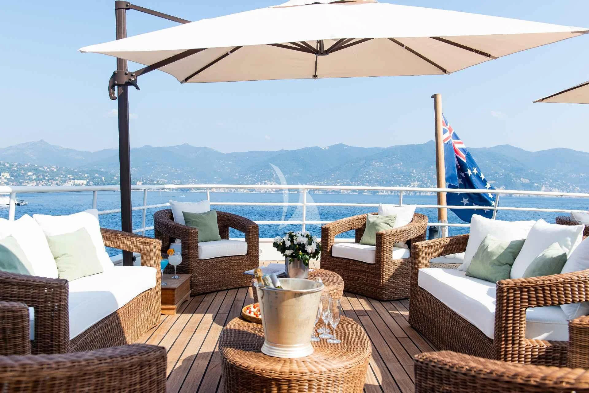 a patio with chairs and a table aboard BLEU DE NIMES Yacht for Charter