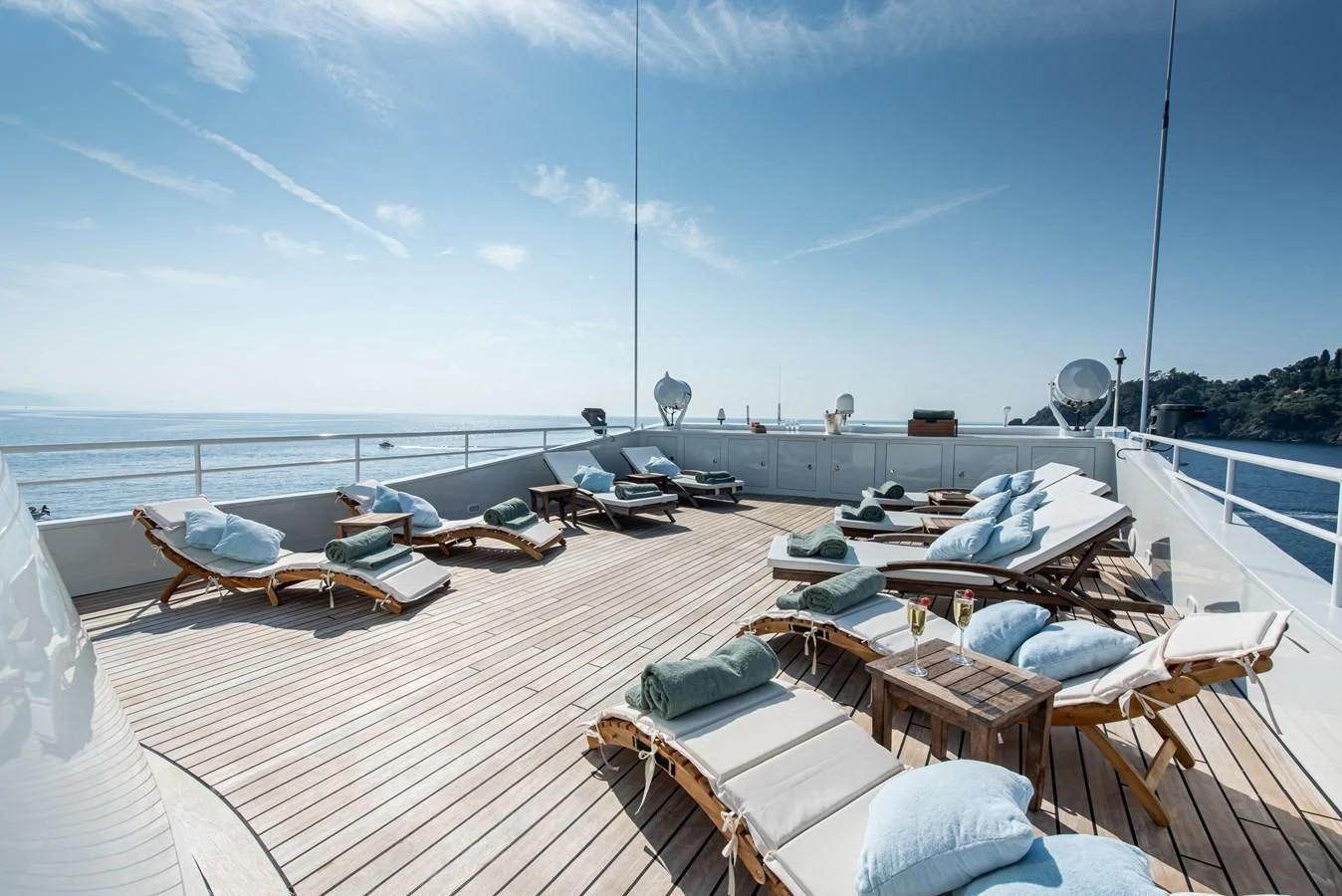 a deck with a view of the ocean and boats aboard BLEU DE NIMES Yacht for Charter