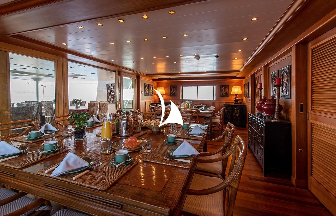 a large dining table with candles aboard BLEU DE NIMES Yacht for Charter