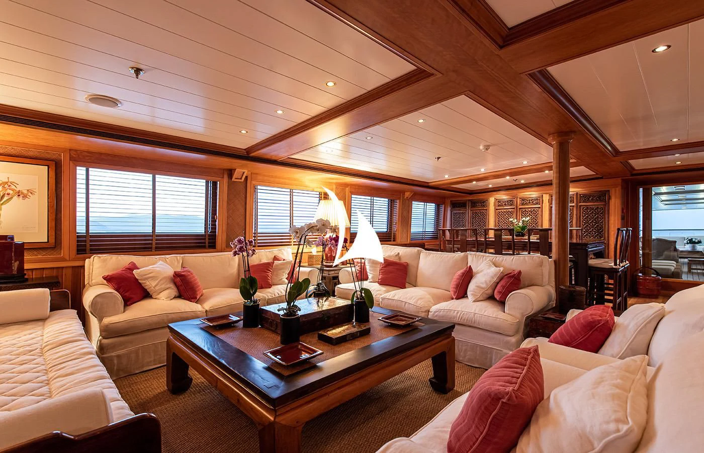 a living room with a table and couches aboard BLEU DE NIMES Yacht for Charter
