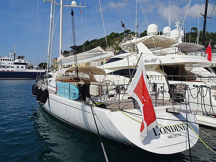 a boat with a flag on it aboard L'ONDINE Yacht for Sale
