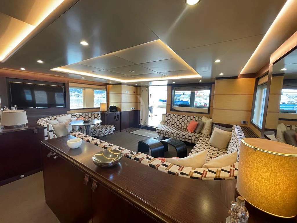 a kitchen with a bar and a table aboard INDIAN Yacht for Sale