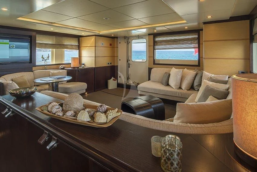 a living room with a large sofa aboard INDIAN Yacht for Sale