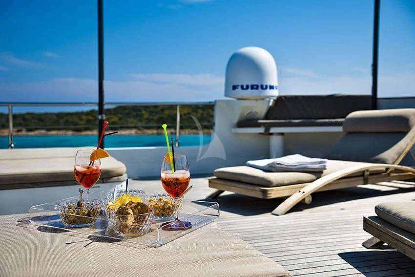 a table with food and drinks on it aboard INDIAN Yacht for Sale