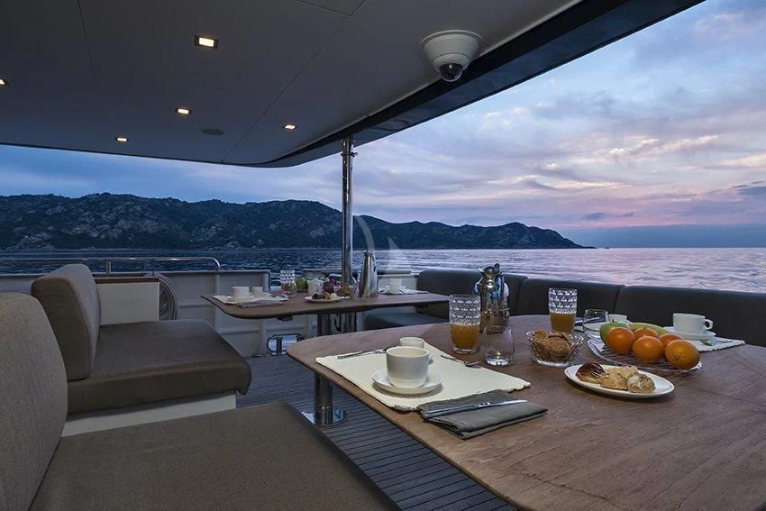 a table with food and drinks on it aboard INDIAN Yacht for Sale