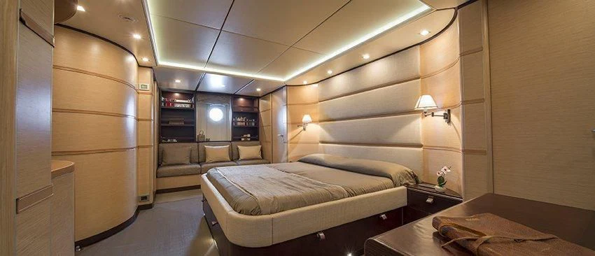a room with a bed and a couch aboard INDIAN Yacht for Sale