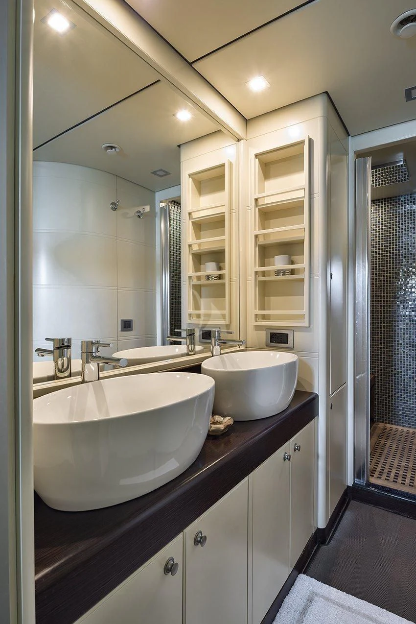 a bathroom with a sink and a mirror aboard INDIAN Yacht for Sale