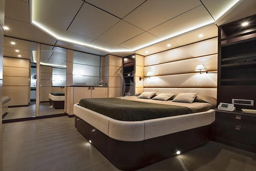 a large bedroom with a bed aboard INDIAN Yacht for Sale