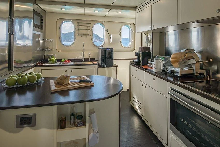 a kitchen with a countertop sink and a dishwasher aboard INDIAN Yacht for Sale
