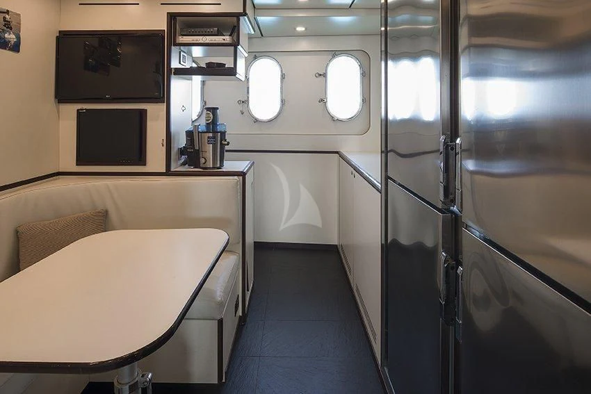 a room with a table and chairs aboard INDIAN Yacht for Sale