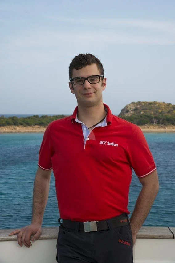a man standing on a dock aboard INDIAN Yacht for Sale