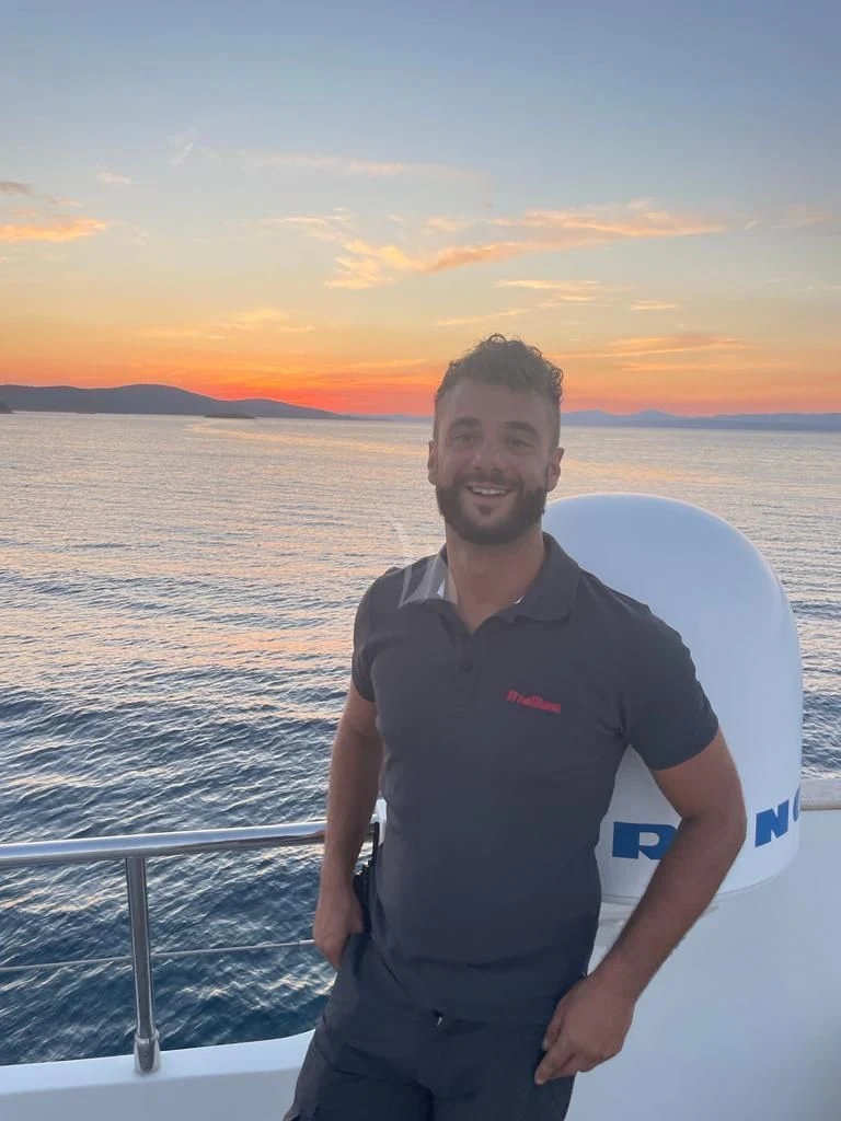 a man standing on a boat aboard INDIAN Yacht for Sale