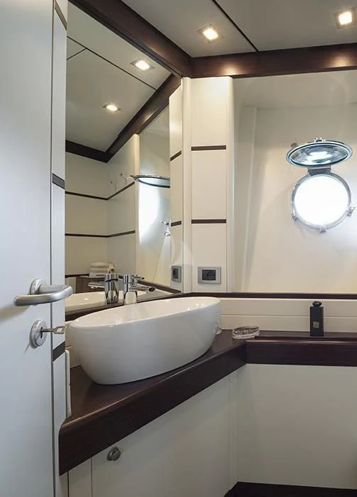 a bathroom with a sink and a mirror aboard INDIAN Yacht for Sale