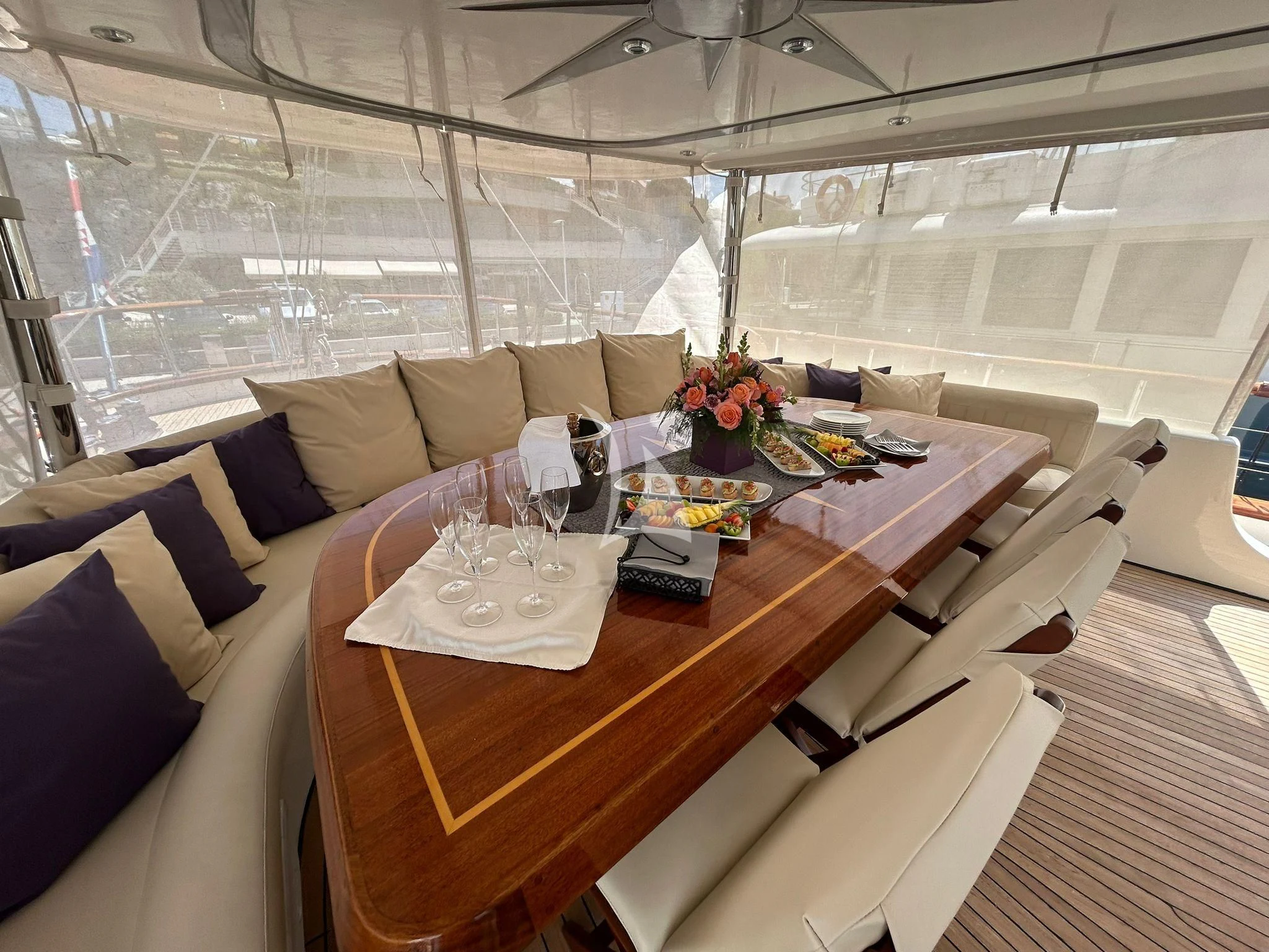 a table with a glass and a couch in a room with a window aboard ALESSANDRO I Yacht for Sale