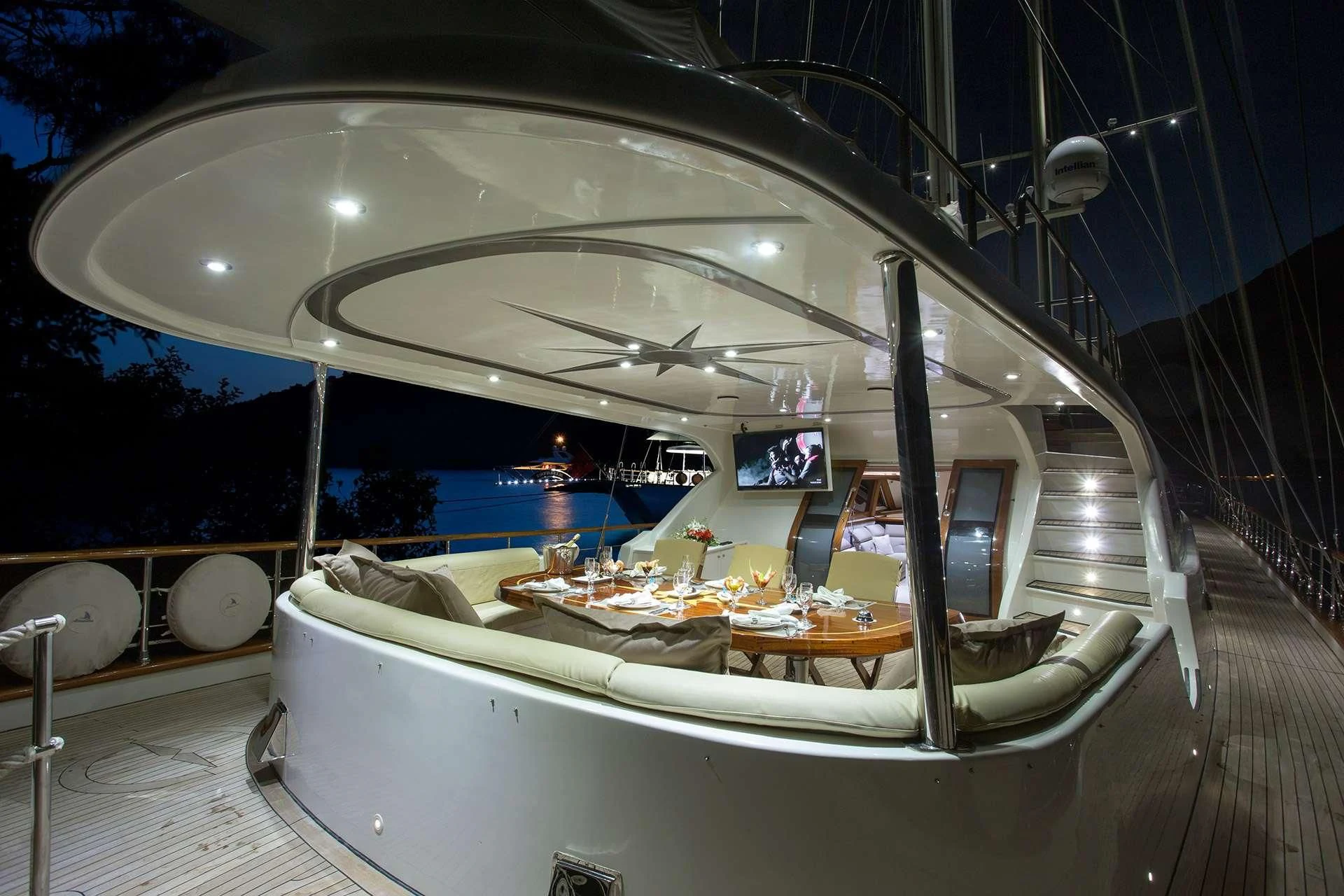 a room with a large bed and a table with food on it aboard ALESSANDRO I Yacht for Sale