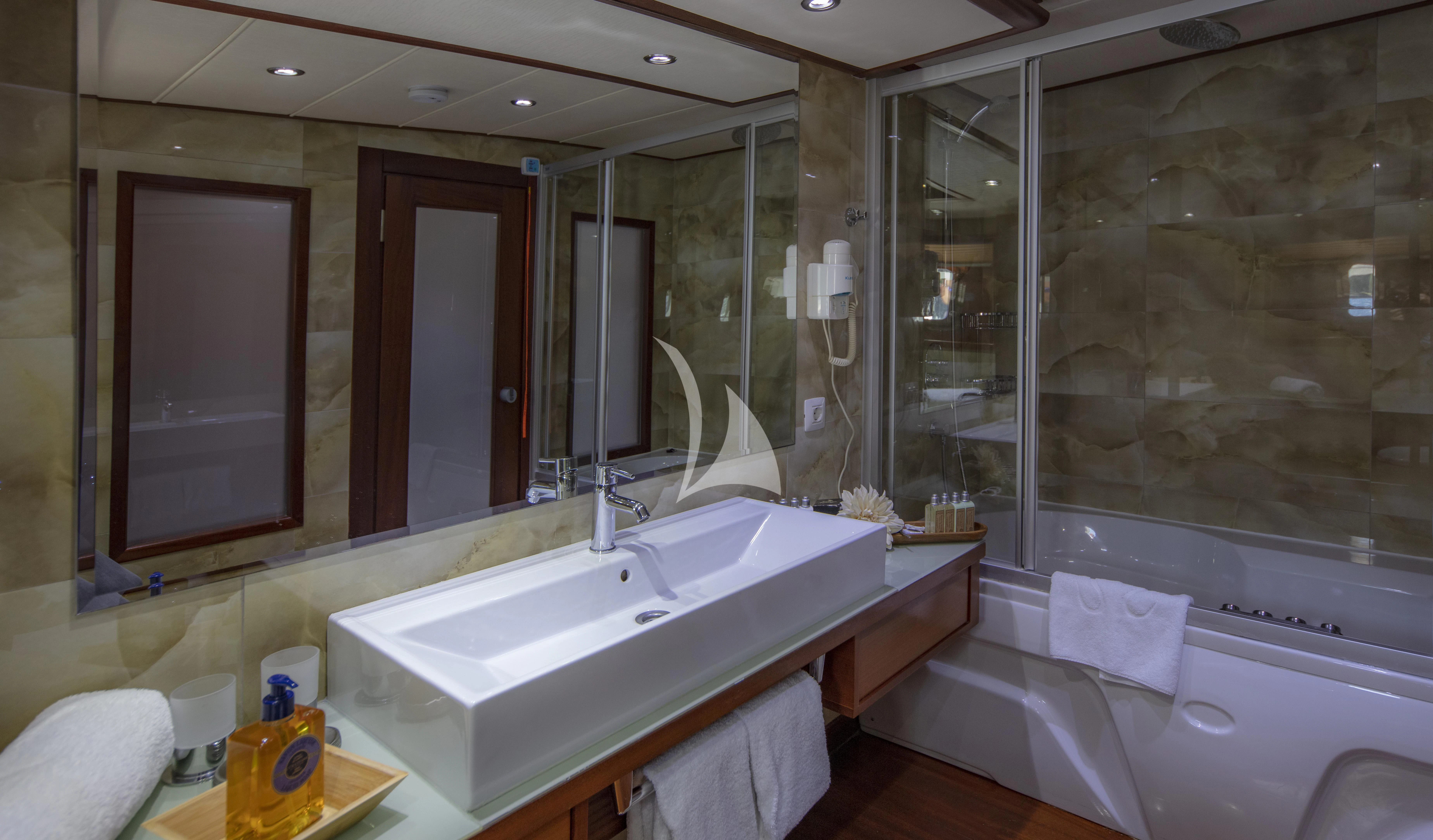 a bathroom with a tub sink and a shower unit aboard ALESSANDRO I Yacht for Sale