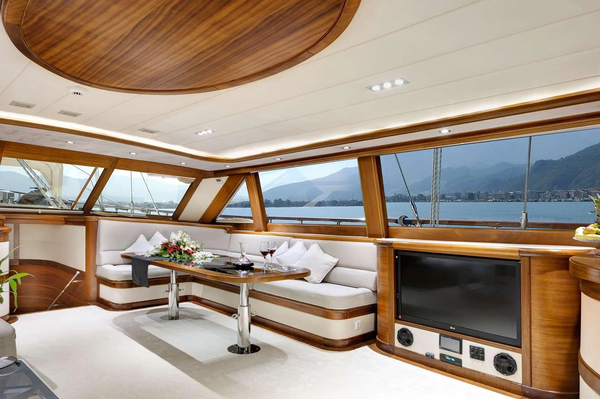 a living room with a tv and a table aboard ALESSANDRO I Yacht for Sale