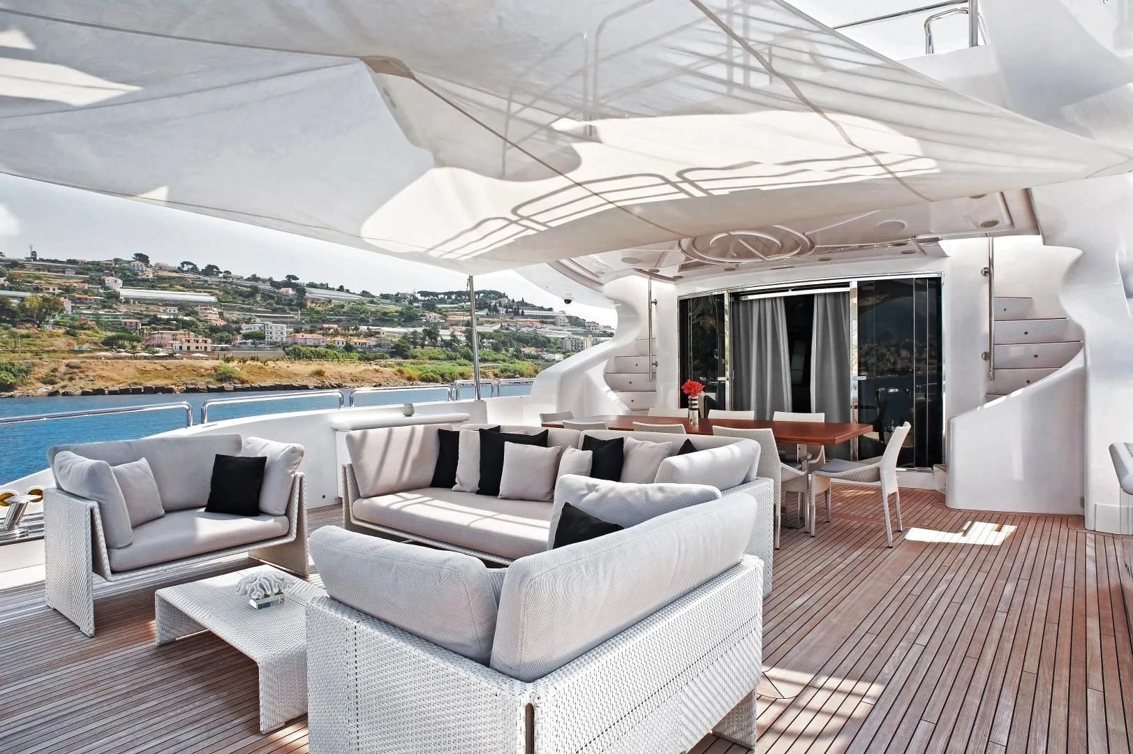 a living room with a large white umbrella over the ocean aboard TUTTO LE MARRANE Yacht for Charter