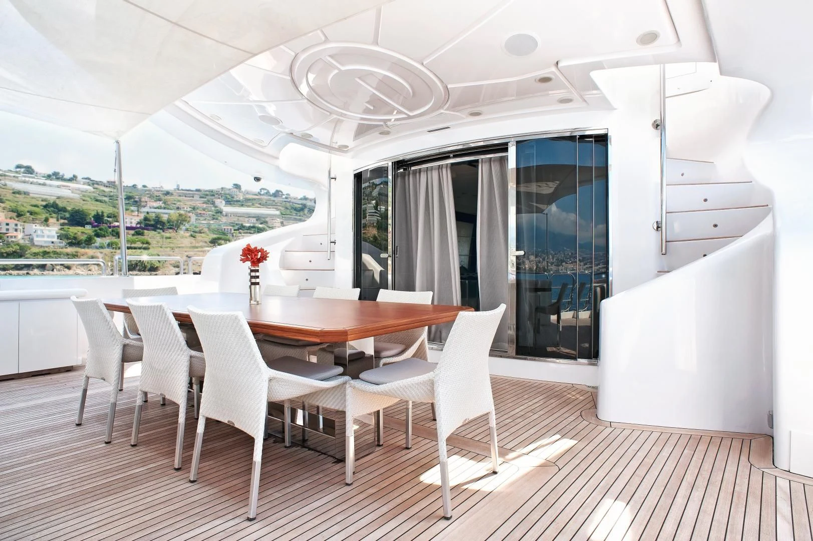 a dining table and chairs in a room with a view of a city aboard TUTTO LE MARRANE Yacht for Charter