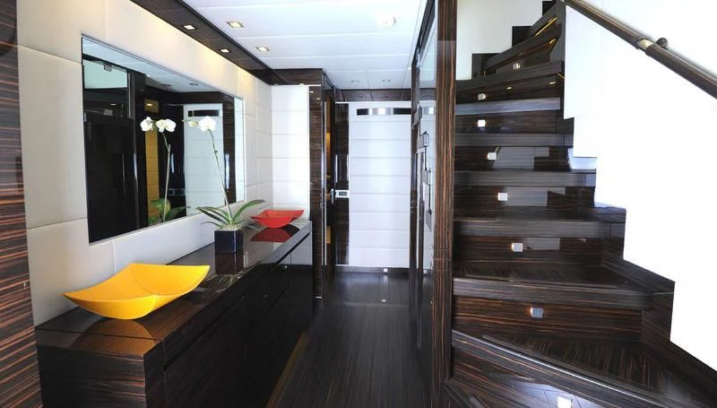 a room with a wood floor and a wood staircase aboard TUTTO LE MARRANE Yacht for Charter