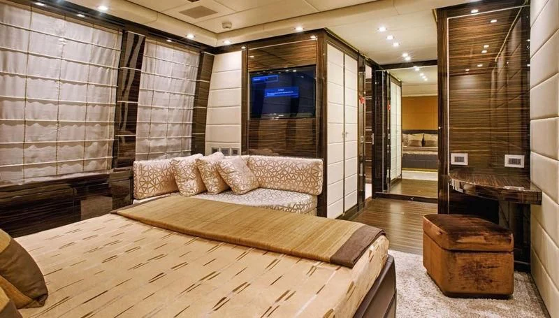 a large room with a bed and a couch aboard TUTTO LE MARRANE Yacht for Charter