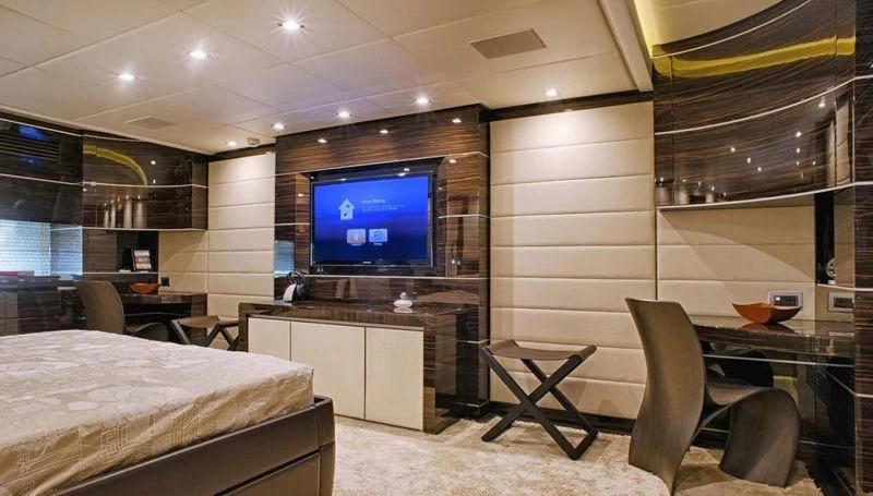 a room with a tv and a bed aboard TUTTO LE MARRANE Yacht for Charter