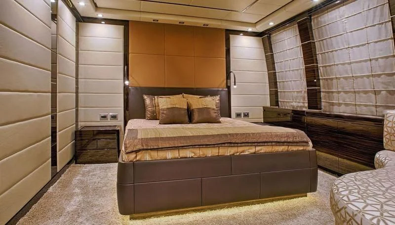 a room with a bed and a couch aboard TUTTO LE MARRANE Yacht for Charter