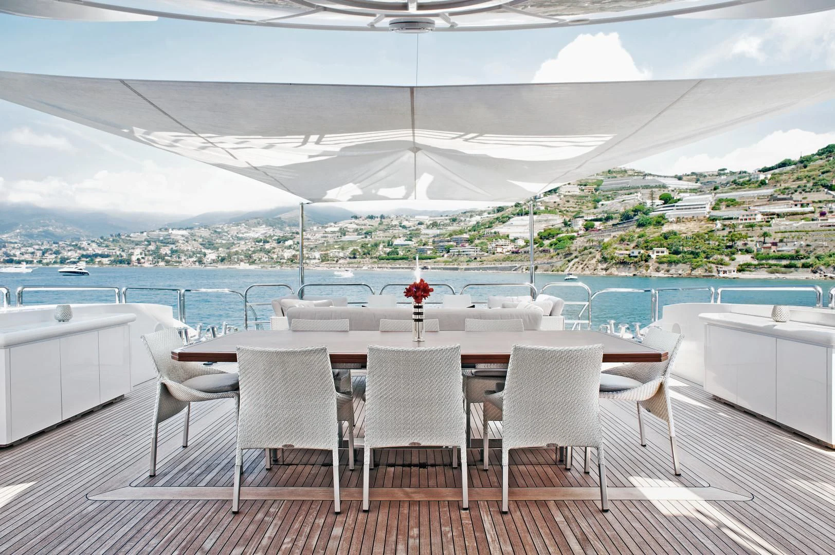 a table set up on a deck overlooking a large body of water aboard TUTTO LE MARRANE Yacht for Charter