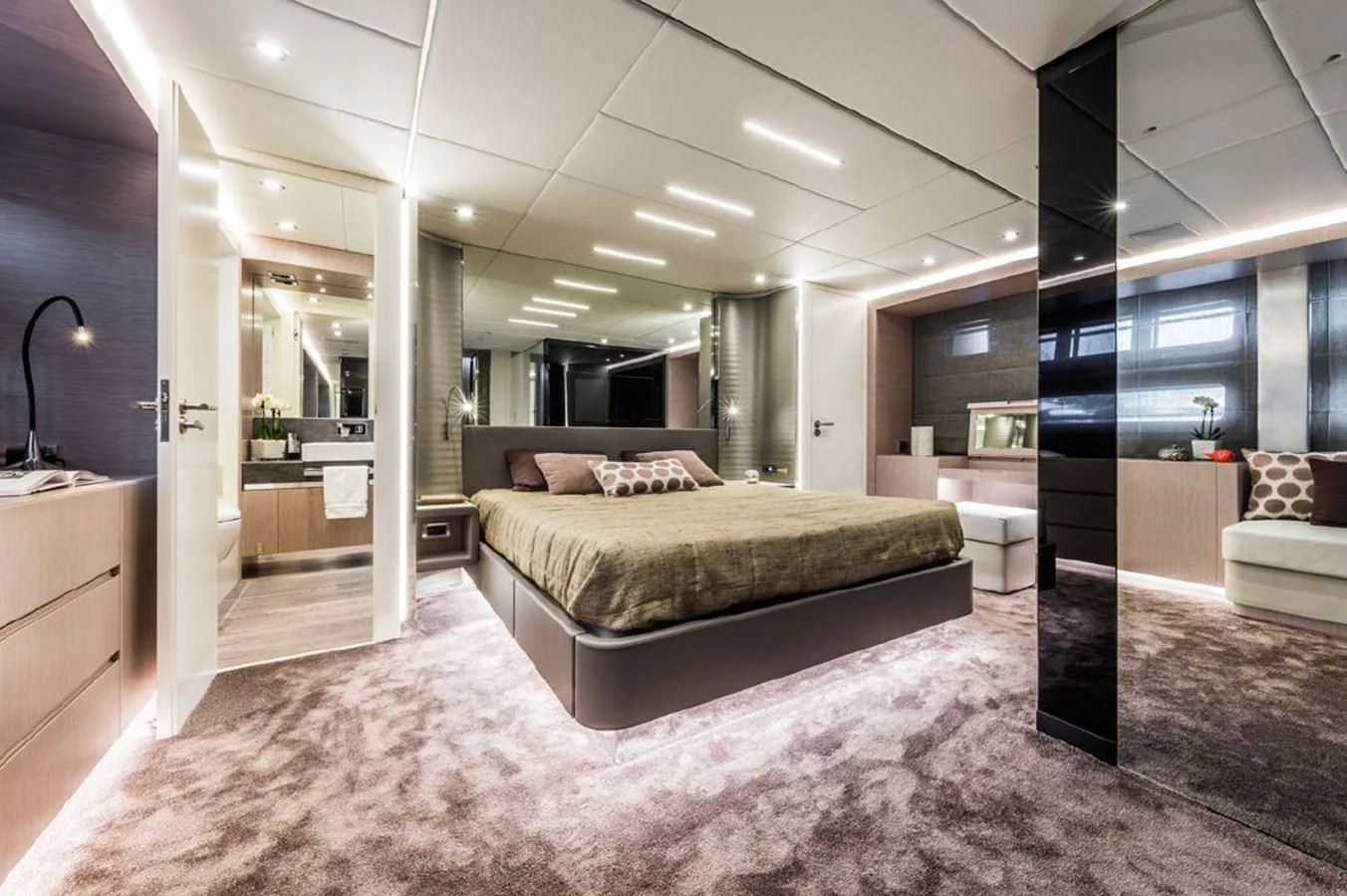 a large bedroom with a large bed aboard BULL Yacht for Sale