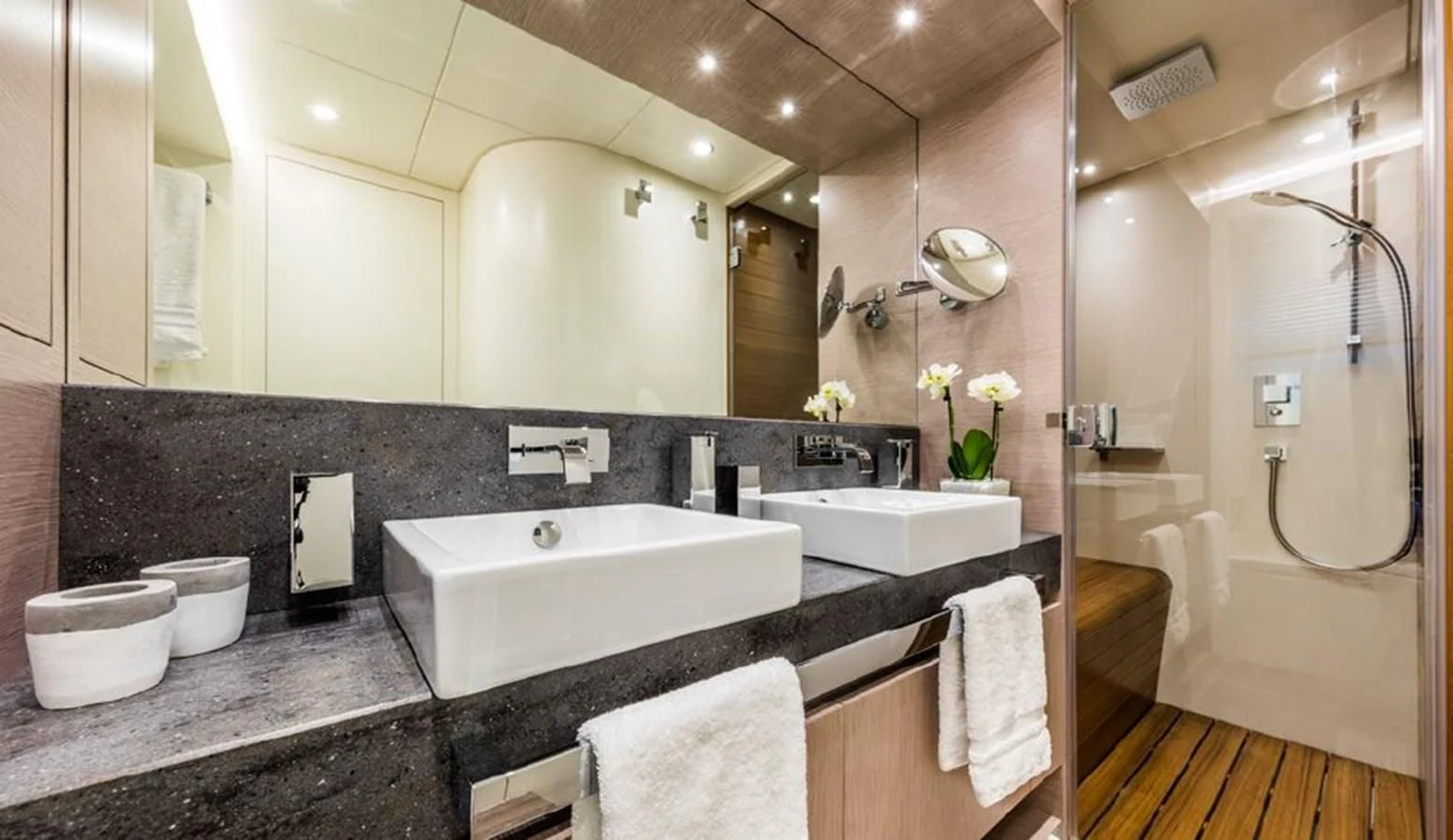 a bathroom with a large mirror aboard BULL Yacht for Sale