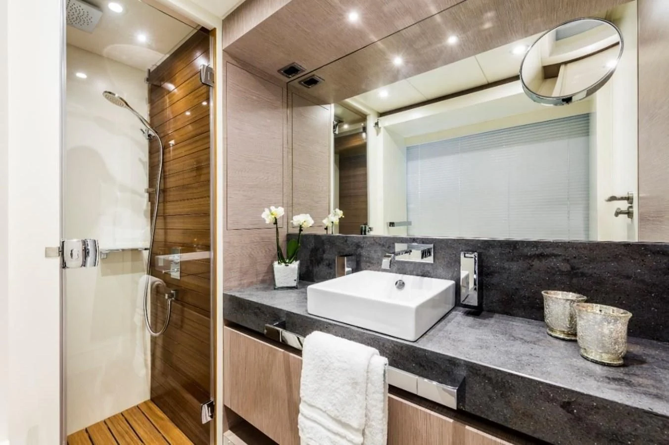 a bathroom with a countertop sink and mirror aboard BULL Yacht for Sale