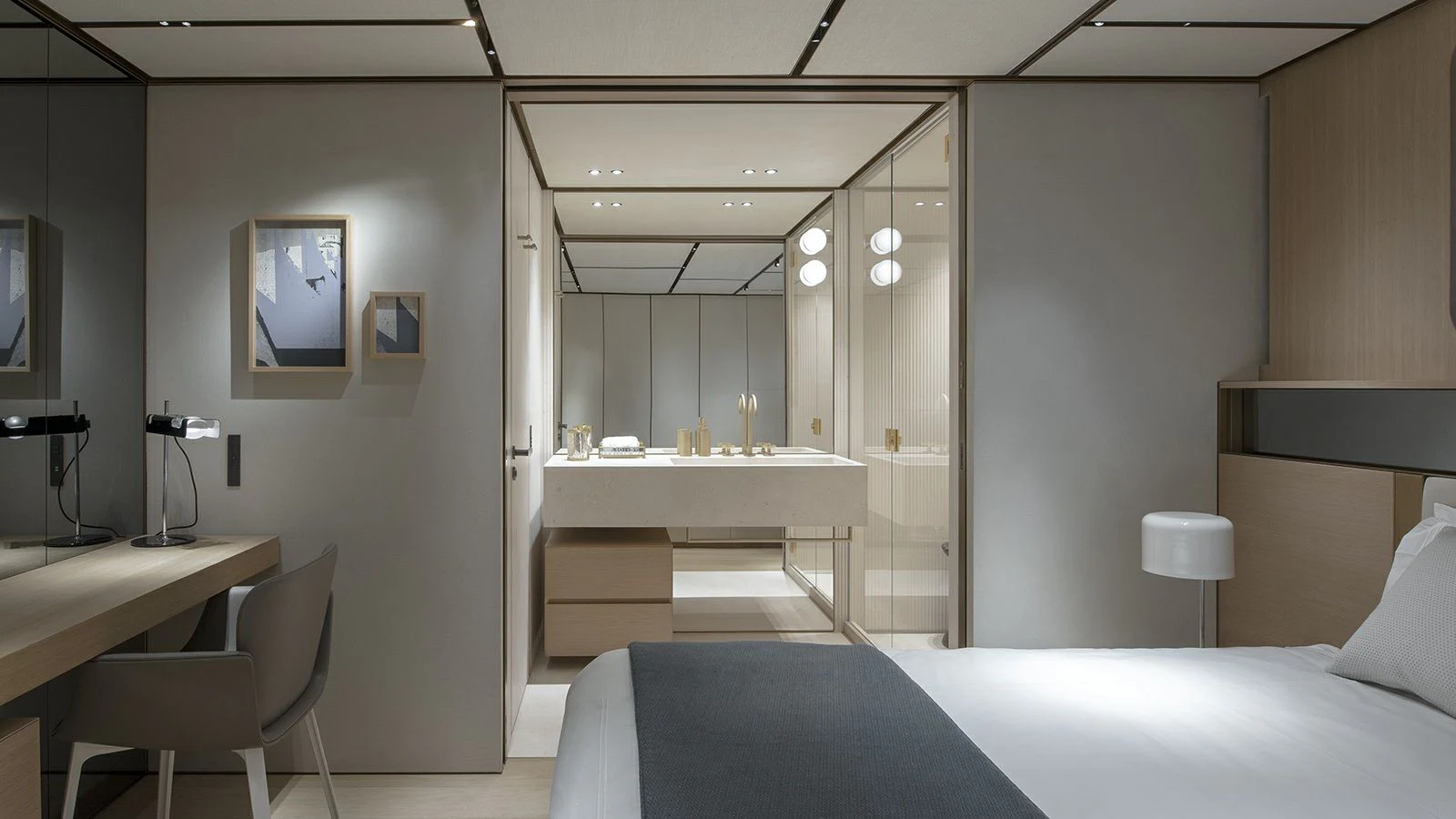 a room with a bed and desk aboard LA LA LAND Yacht for Charter