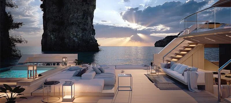 a deck with a view of a body of water and a large rock aboard LA LA LAND Yacht for Charter
