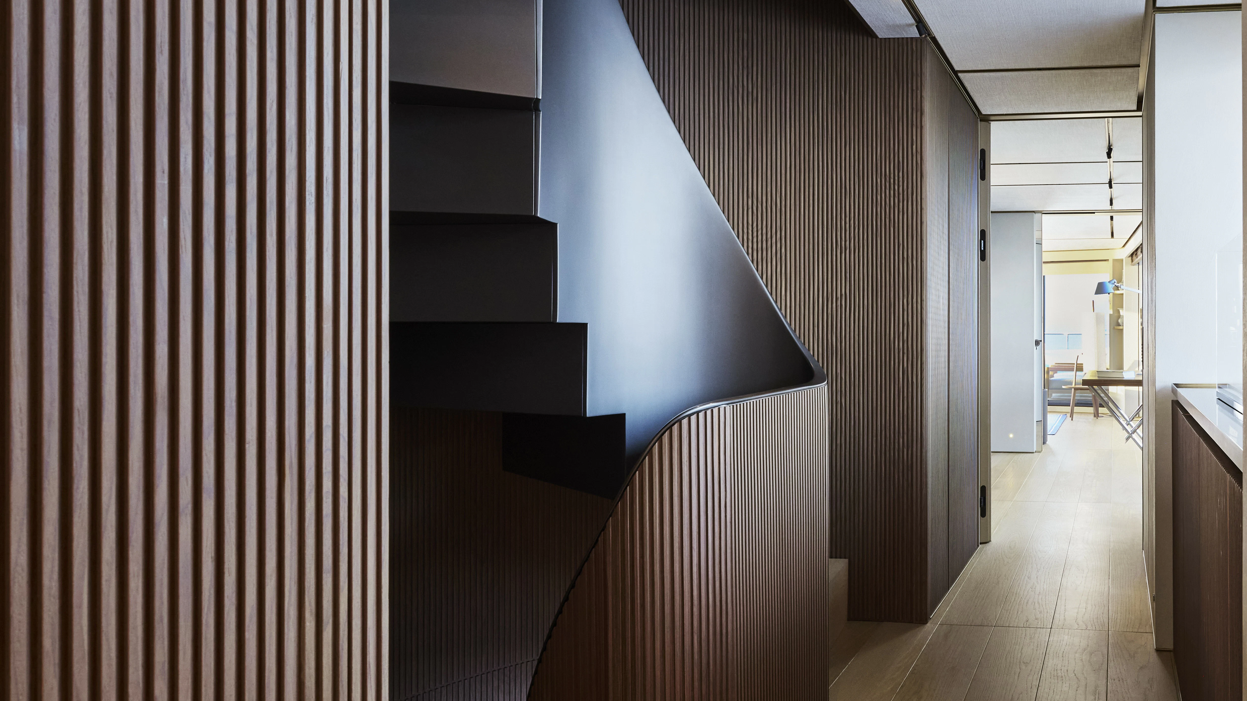a hallway with a black and white wall and black stairs aboard LA LA LAND Yacht for Charter