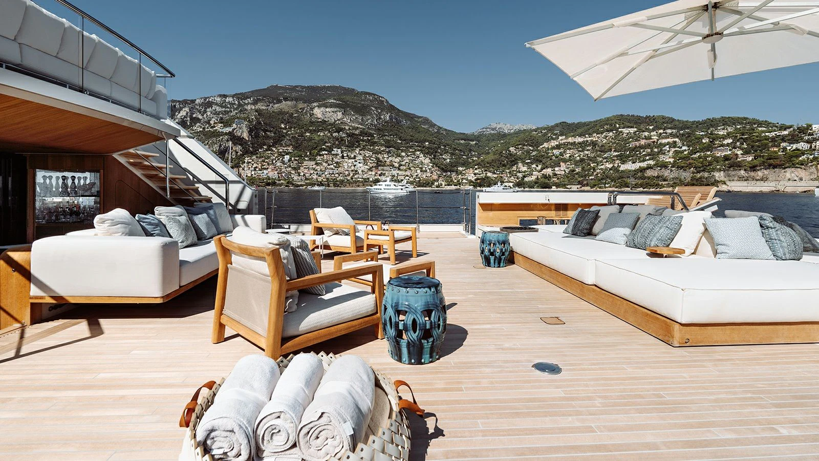 a room with beds and a chair aboard LA LA LAND Yacht for Charter