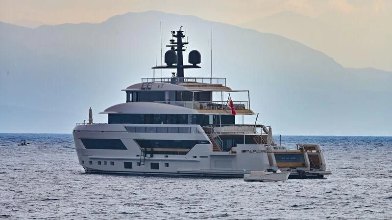 a large ship in the water with Thomas Point Shoal Light in the background aboard LA LA LAND Yacht for Charter