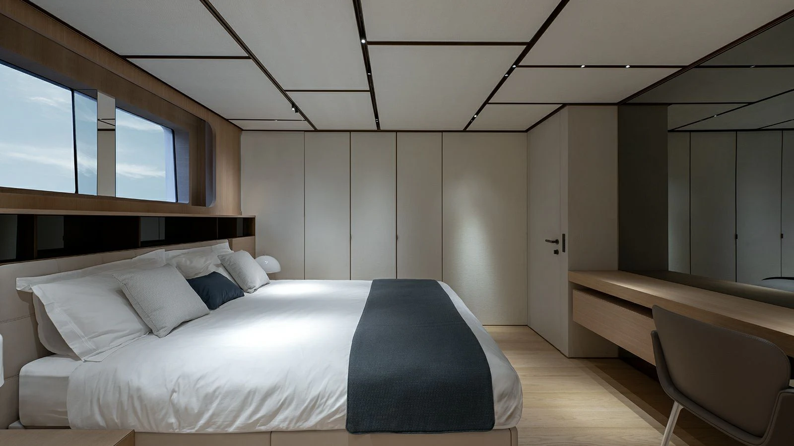 a room with a bed and a desk aboard LA LA LAND Yacht for Charter