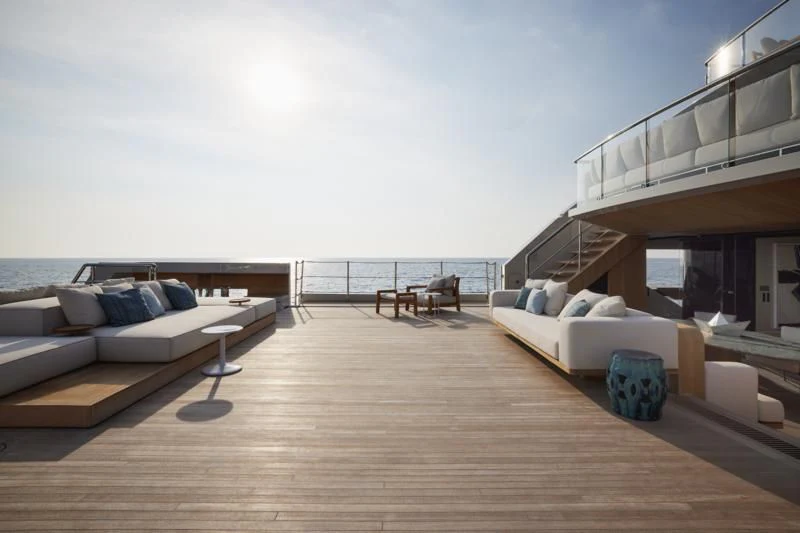 a large wooden deck overlooking a beach aboard LA LA LAND Yacht for Charter