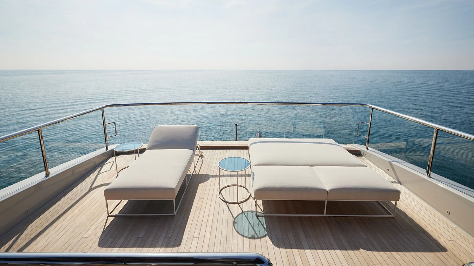 a deck with chairs on it by the ocean aboard LA LA LAND Yacht for Charter